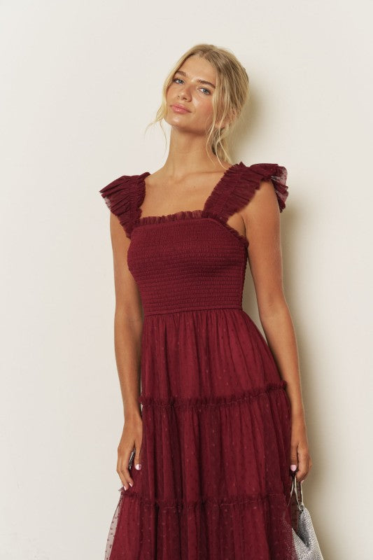 Model wearing a burgundy smocked tiered tulle midi dress