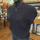 Navy knit sweater top with gold cross necklace on mannequin in the boutique
