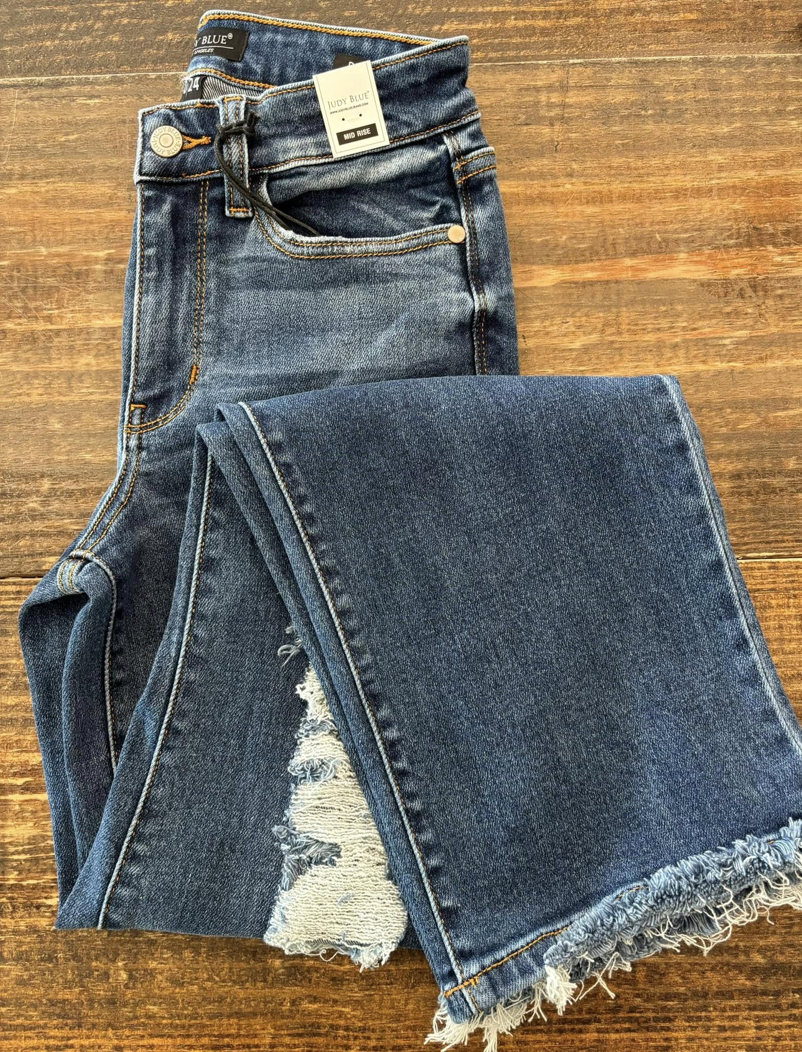 Distressed medium-wash jeans with frayed hem