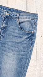 Risen High Rise Flare Jeans | Medium — Front pocket detail