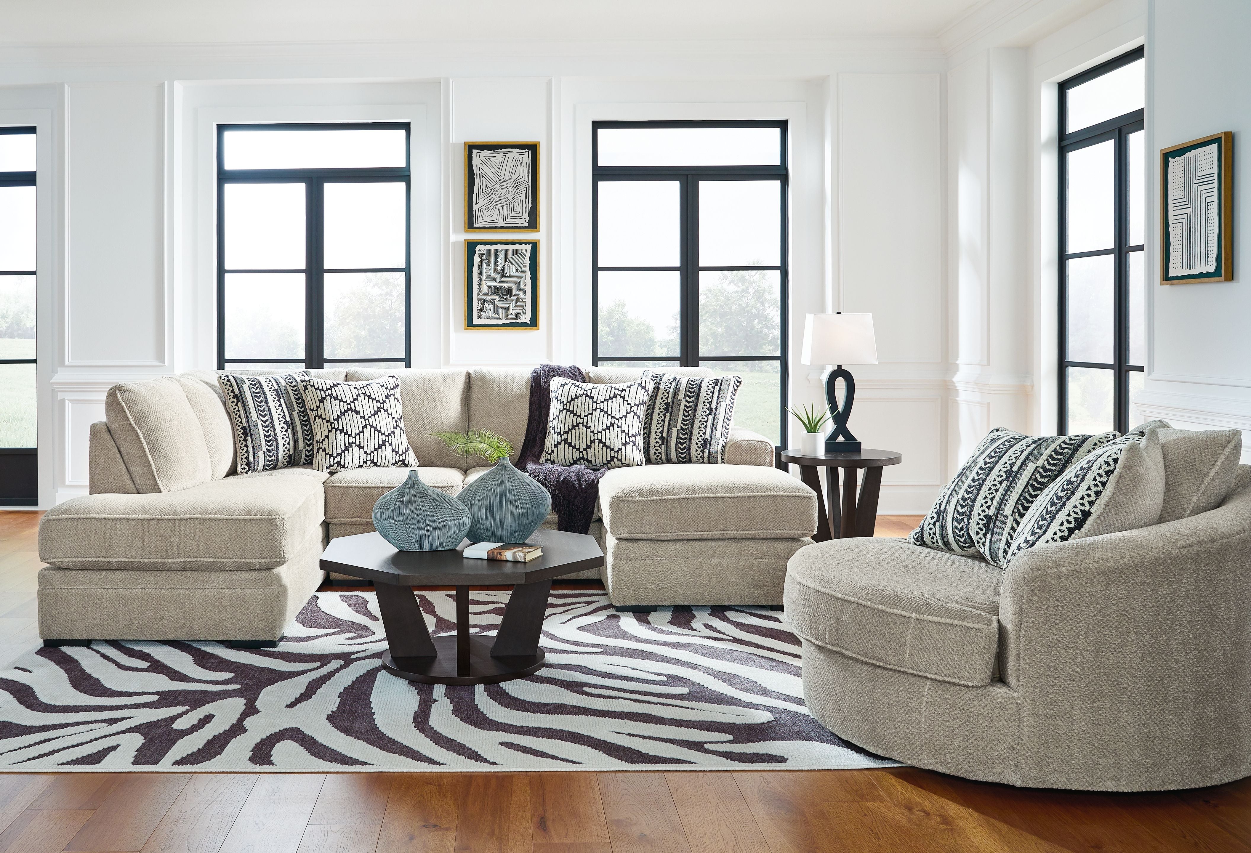 Living room with cream sectional sofa, swivel chair and zebra print rug