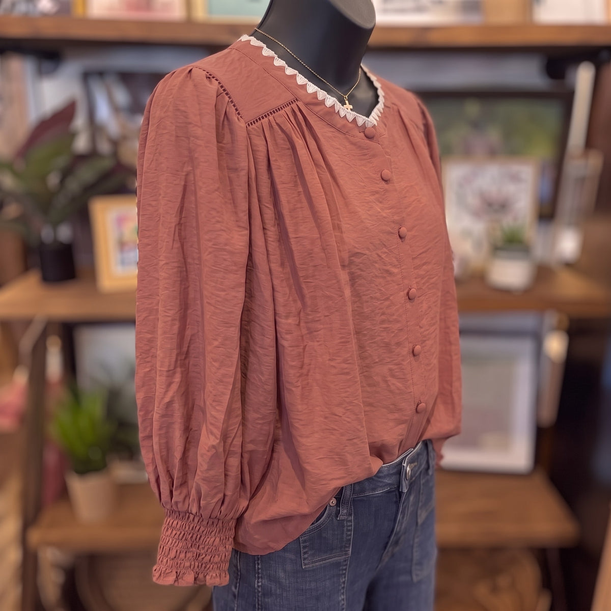Contrast Stitch Button Down Top in maroon on a mannequin, side angle showing the full balloon sleeves
