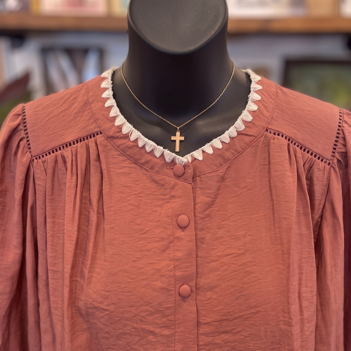 Close-up of the Contrast Stitch Button Down Top in maroon: cream zigzag neckline trim, open-weave yoke seams and fabric-covered buttons